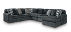 Dark gray corduroy sectional sofa with corner chaise and patterned accent pillows