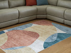 Geometric washable rug with blue, coral, beige, and gray abstract circles and blocks