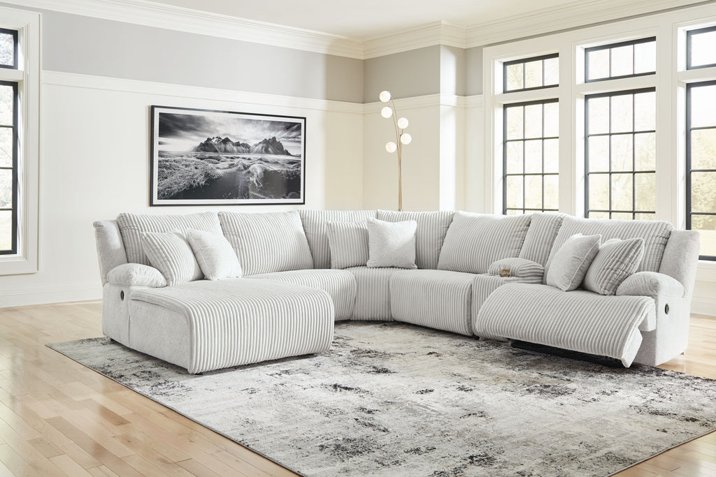 Light gray striped reclining sectional sofa with chaise and padded armrests