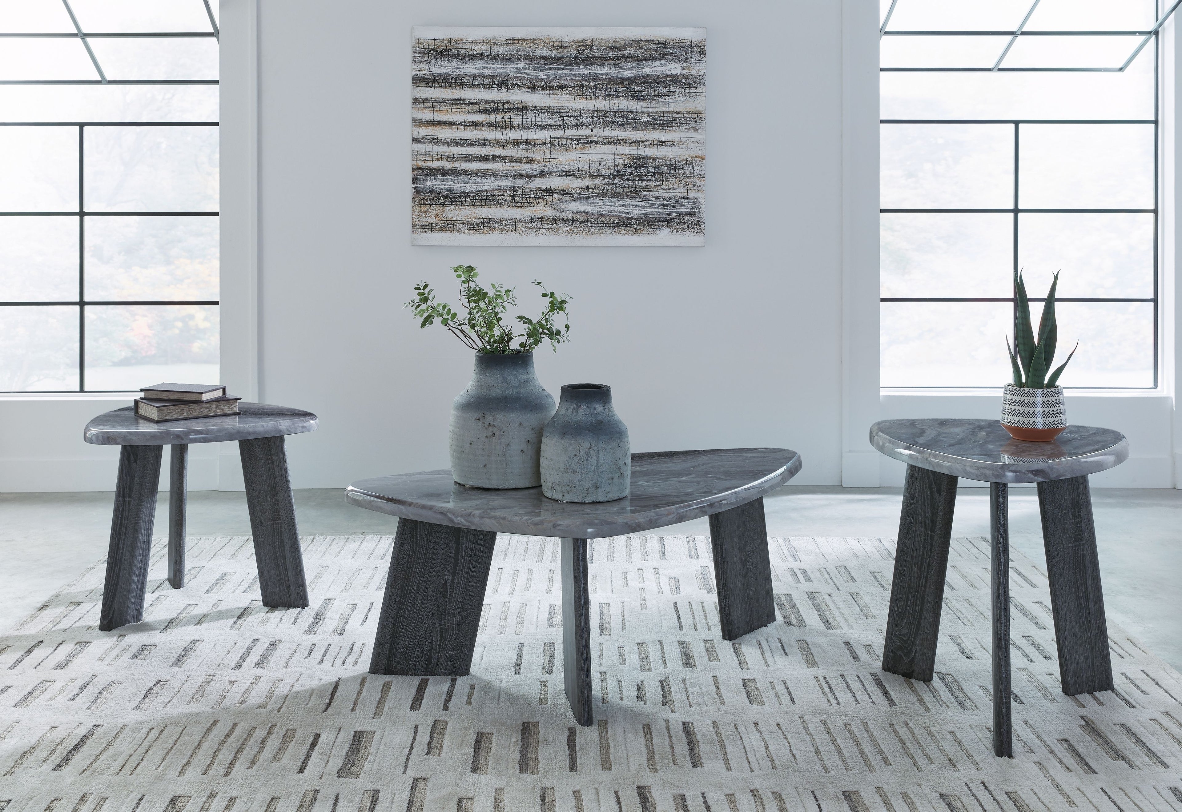 Set of 3 round gray occasional tables with dark tapered legs, staggered arrangement