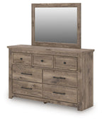 Light brown dresser with mirror and seven drawers with bar pulls