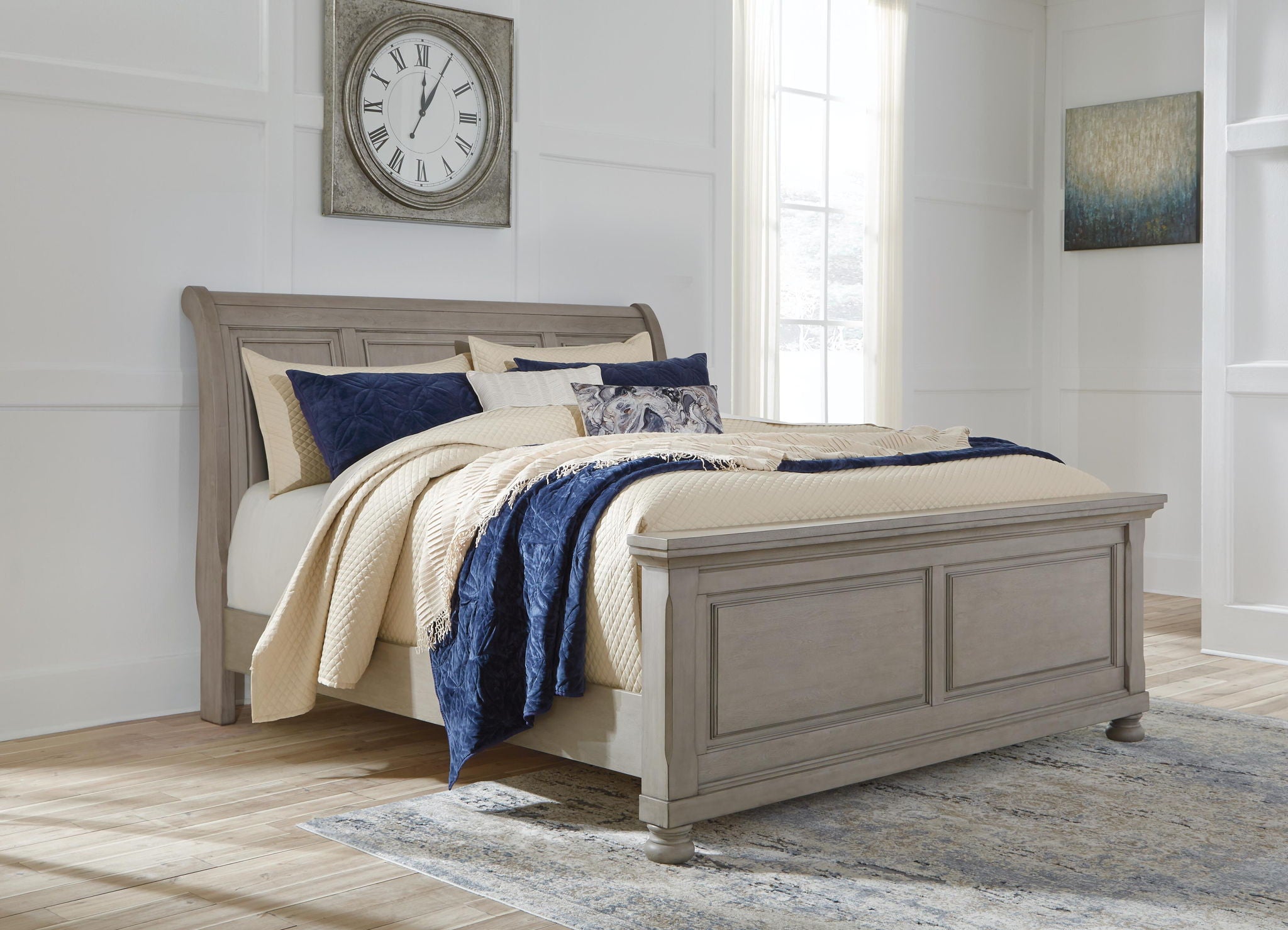 Lettner sleigh bed with two drawers, gray frame and blue-and-cream bedding