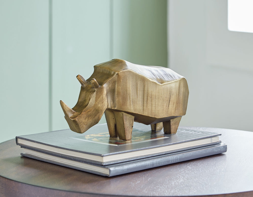 Antique gold elephant sculpture standing on a stack of books