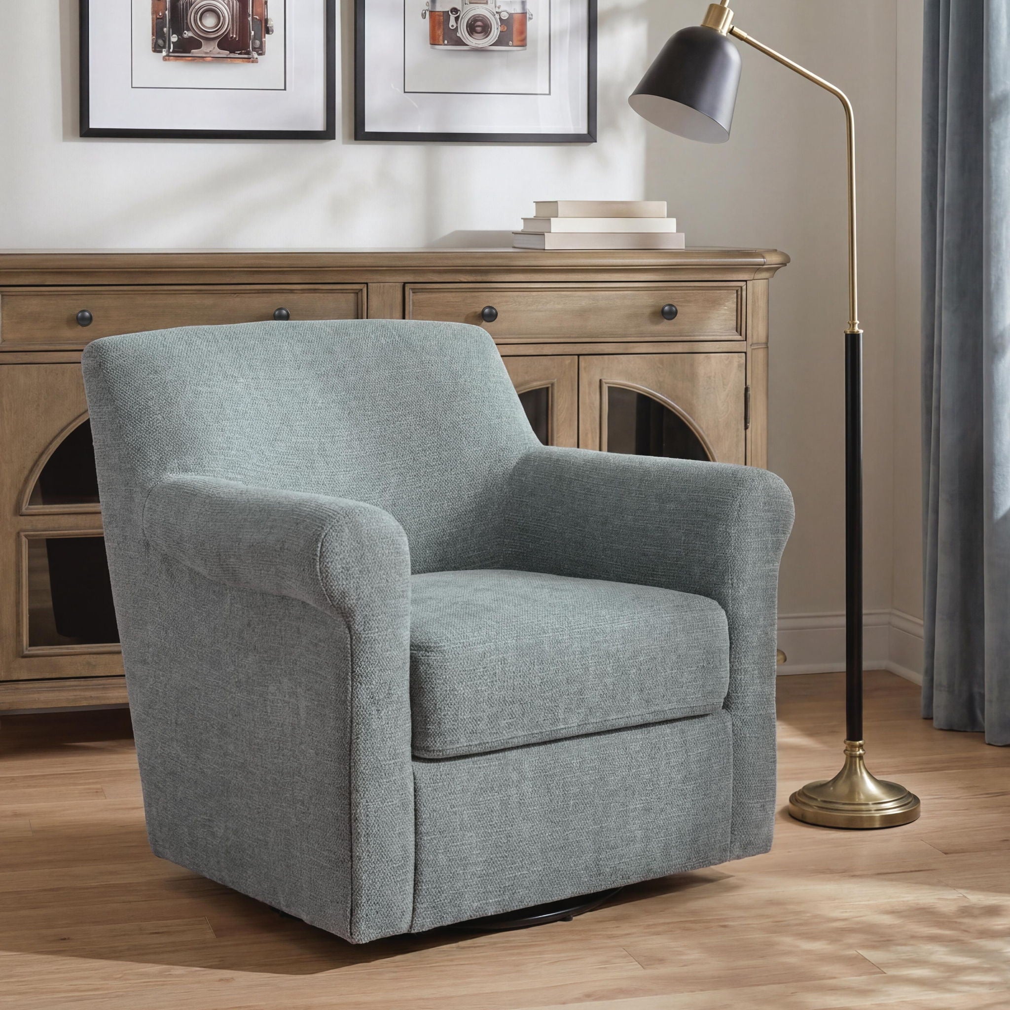 Gray swivel accent chair with padded arms, boxy seat, and fabric upholstery
