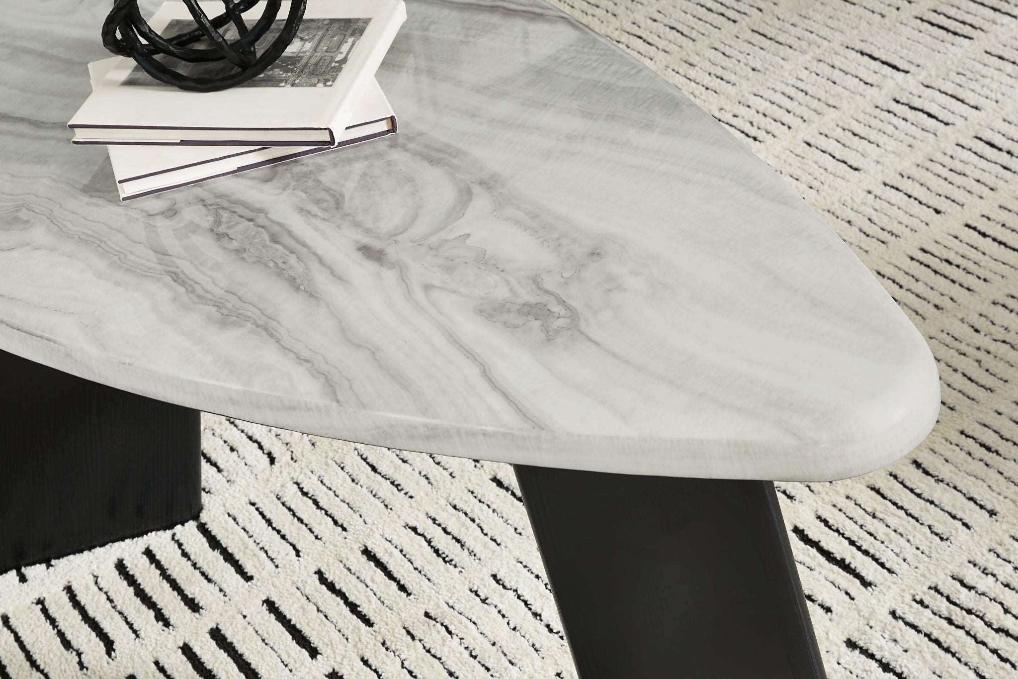 Marble-look gray tabletop with swirled veining and black angled support legs