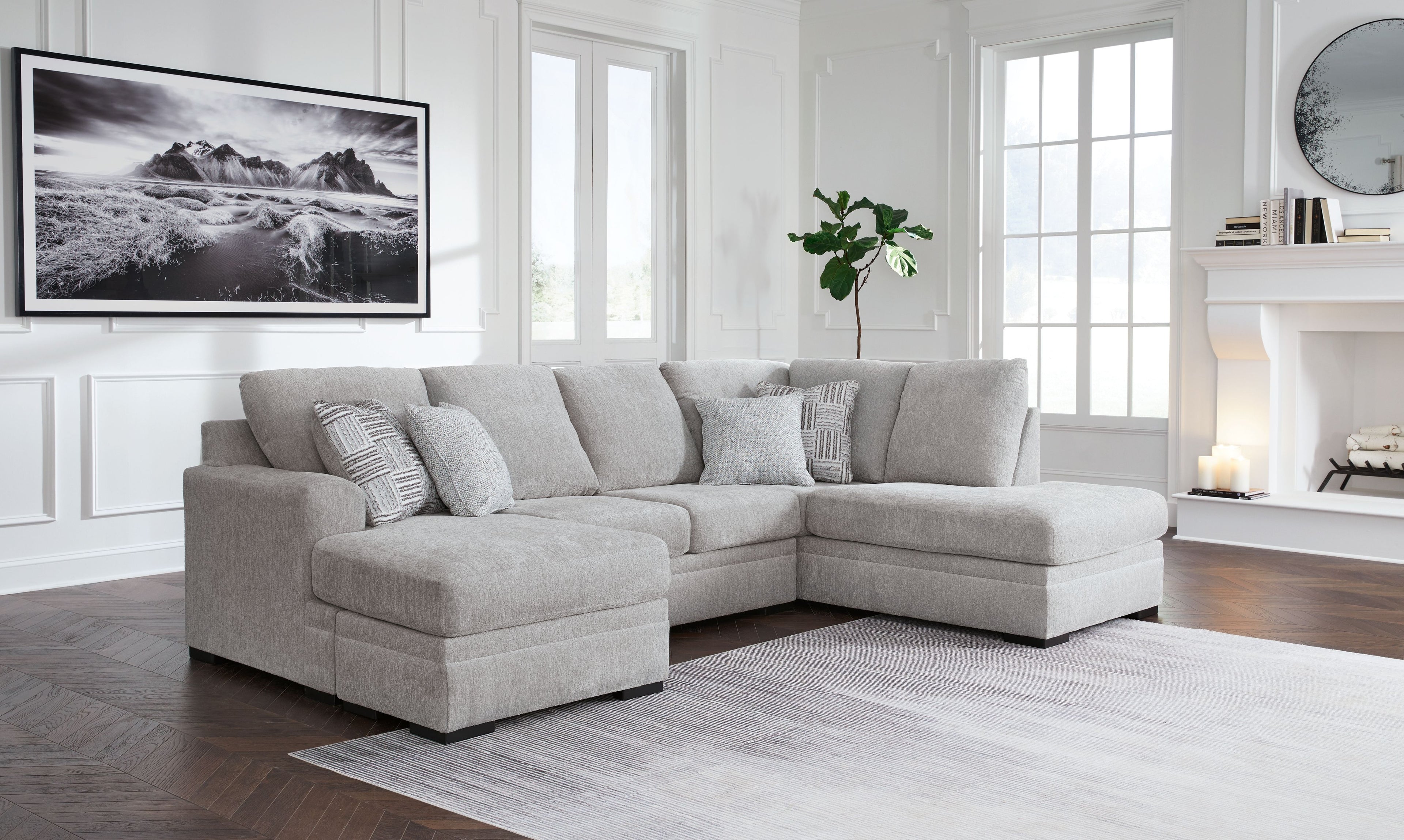 Gray sectional sofa with chaise, four back pillows, low arms, tufted seat cushions