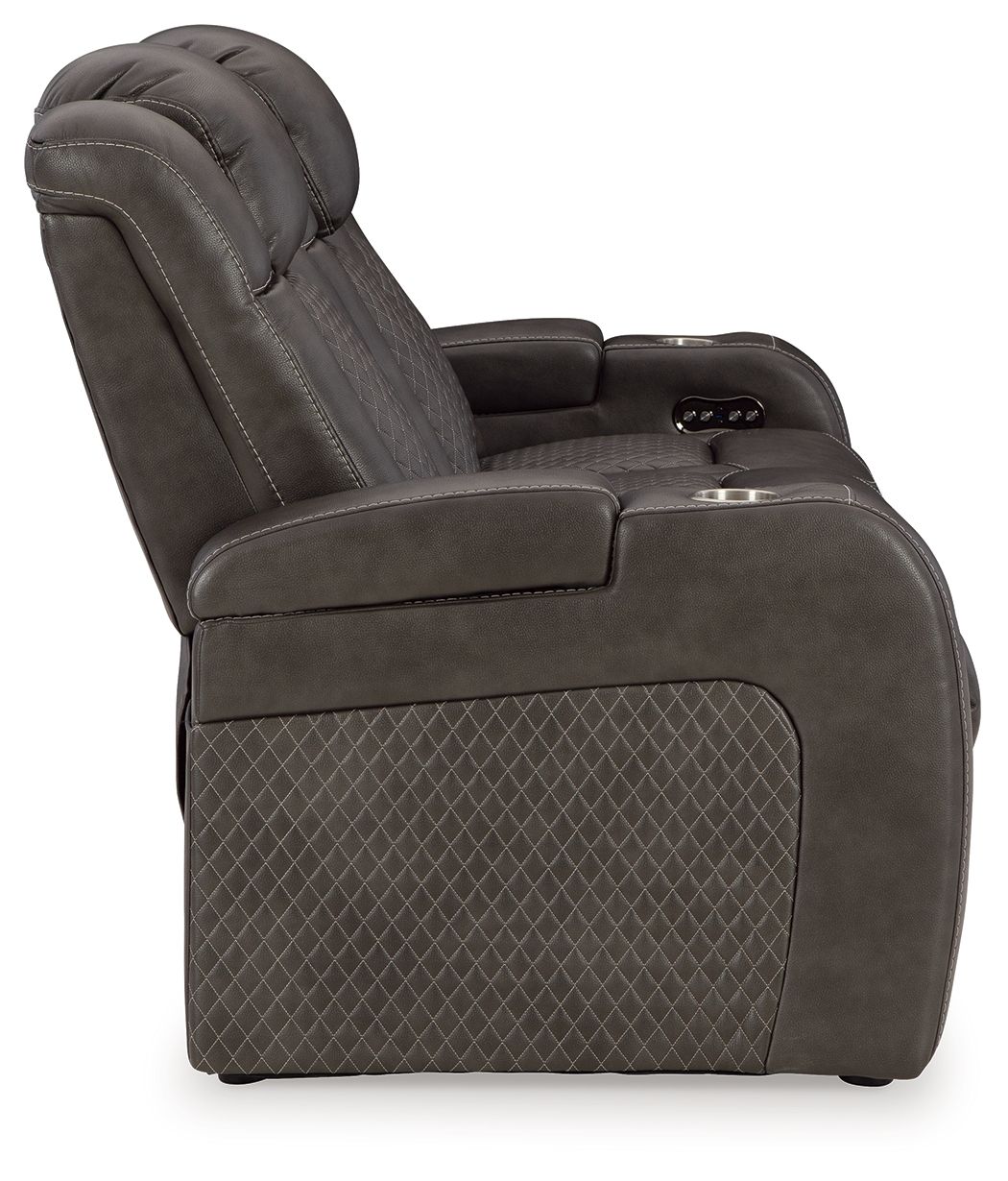 Dark gray upholstered recliner chair with padded armrests and control panel