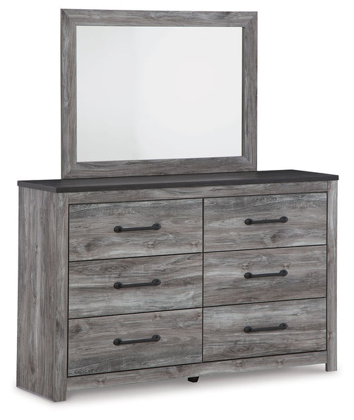 Dark gray dresser with six drawers and a mirror above, metal bar handles