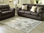 Rectangular washable rug in beige and gray distressed abstract design, low pile