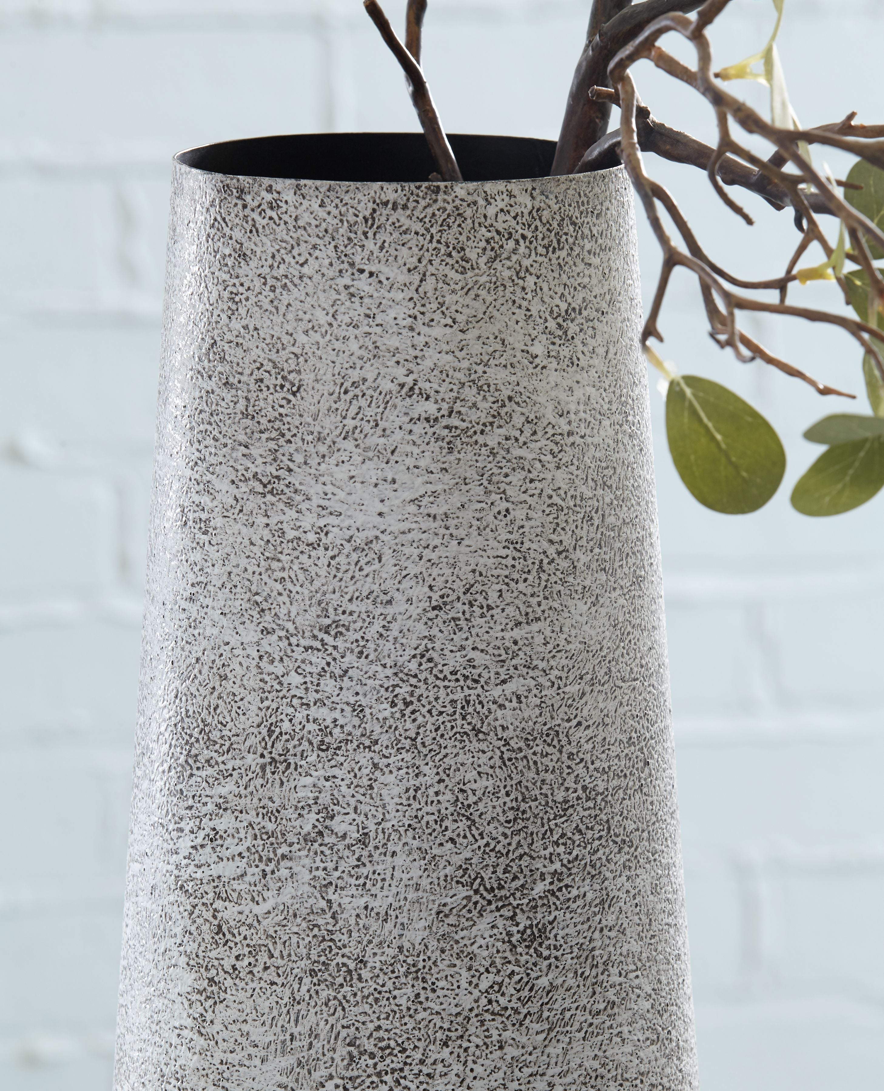 Ceramic vase in light gray speckled finish with flared open top and smooth sides.