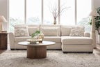 Light beige sectional sofa with chaise, square arms, and solid and patterned pillows