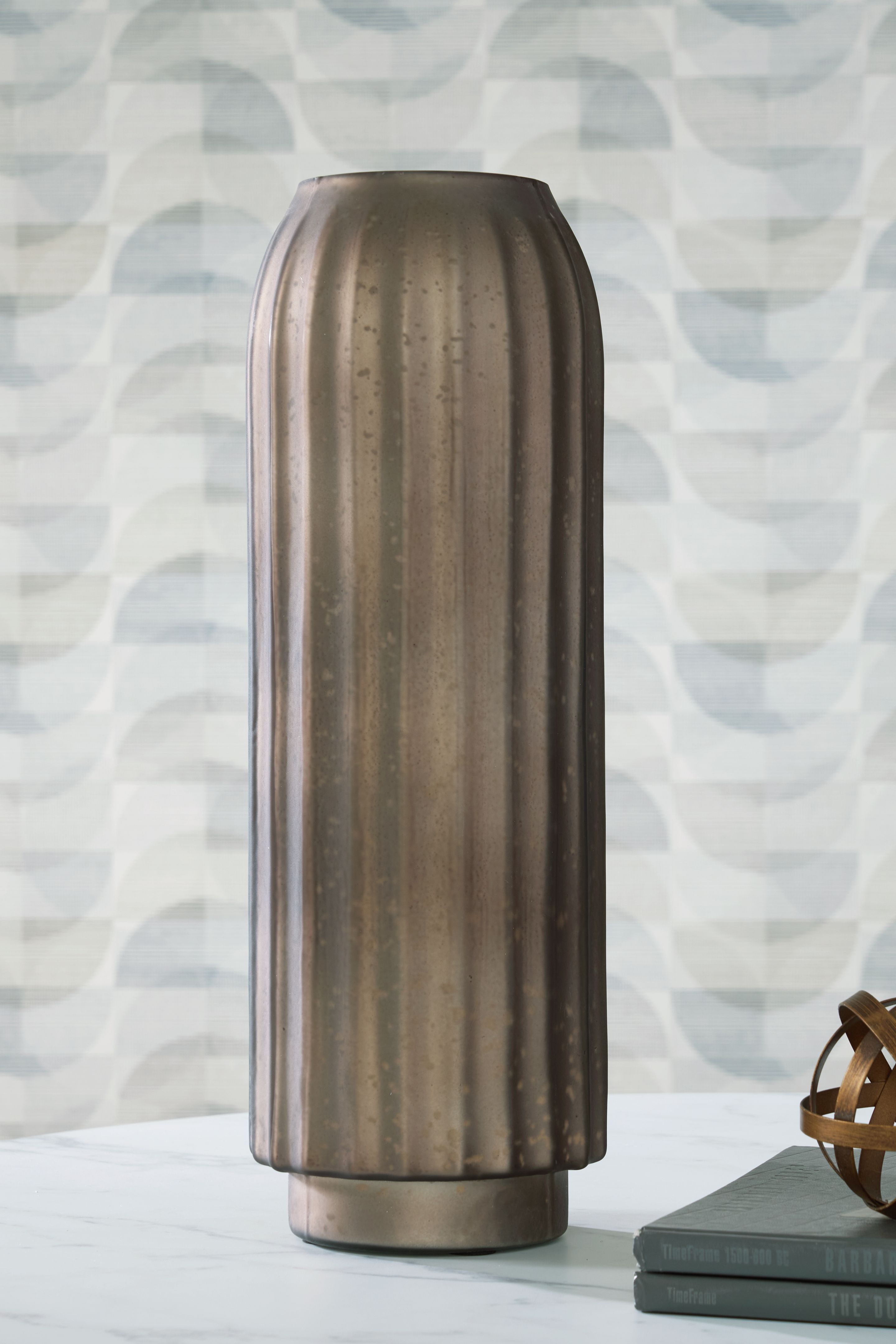 Metal vase, dark bronze, tall fluted sides and round foot base