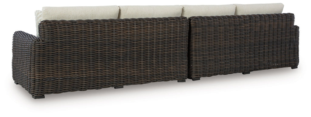 Dark brown wicker loveseat frame with beige back cushions and seat cushions