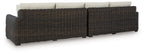 Dark brown wicker loveseat frame with beige back cushions and seat cushions