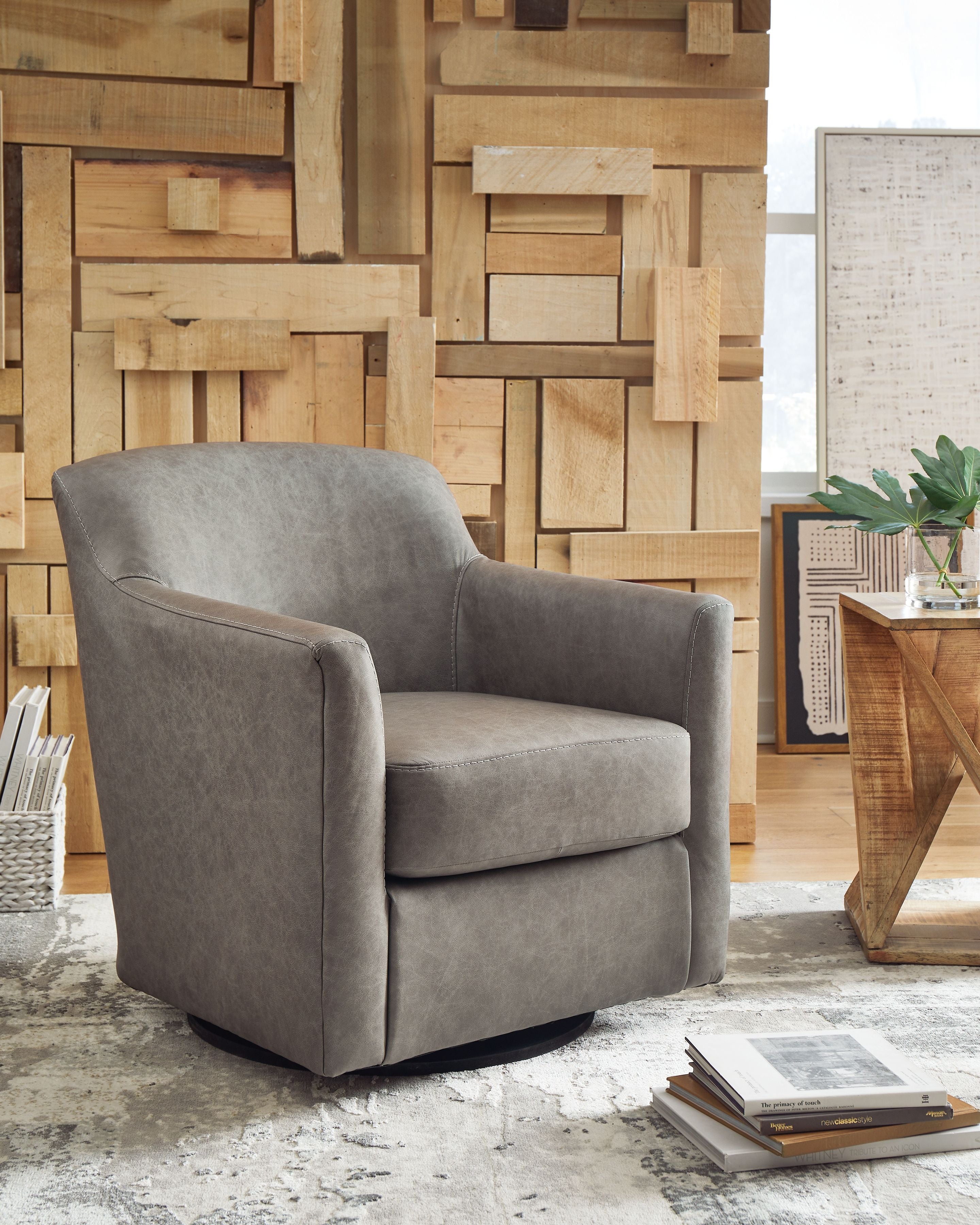 Gray swivel accent chair with cushioned arms, padded seat, and curved rotating base