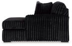 Black ribbed corner chaise with rounded arms and a low backrest