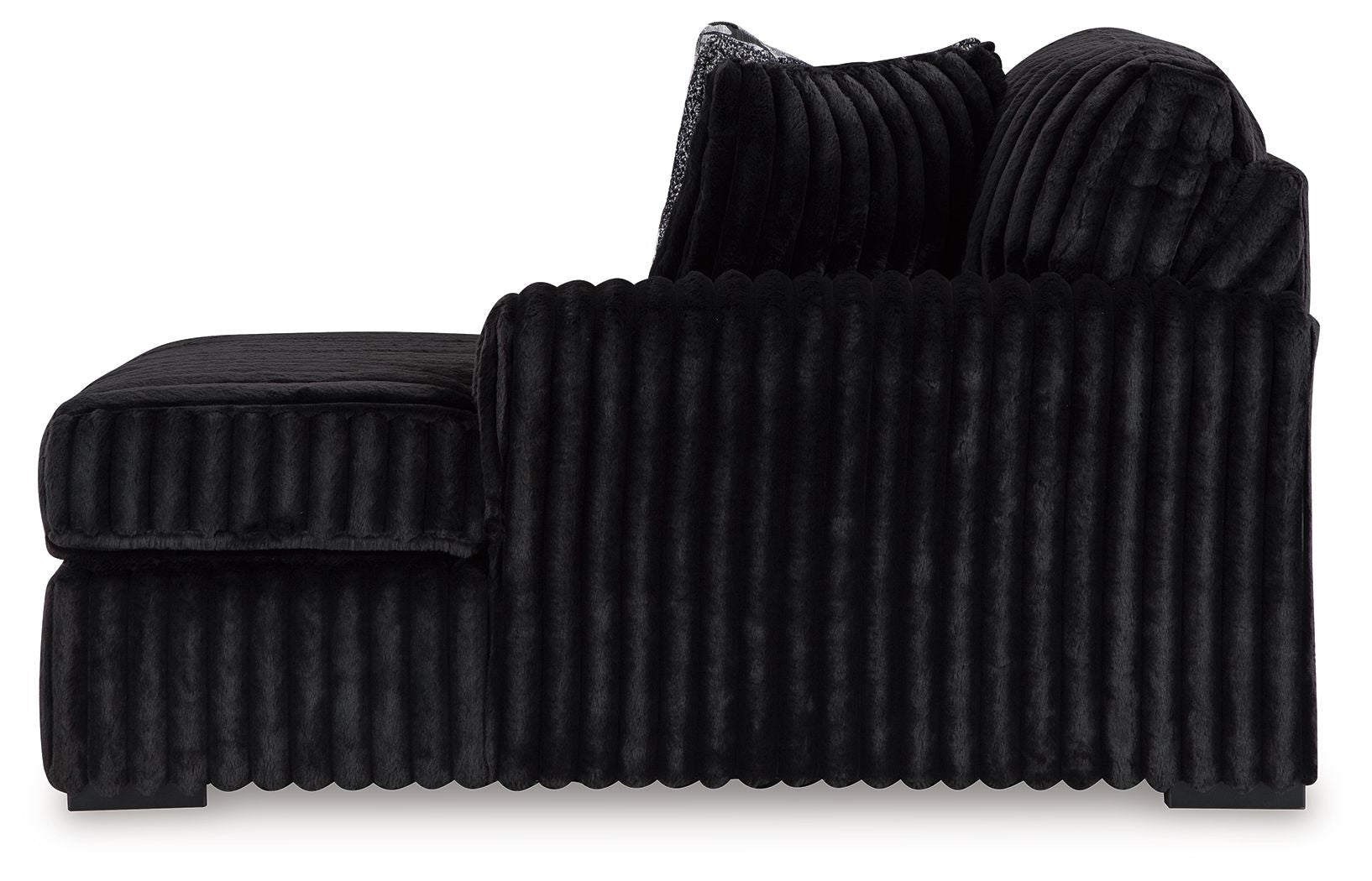 Black ribbed corner chaise with rounded arms and a low backrest