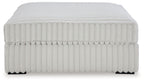 Oversized accent ottoman, light gray ribbed fabric with flat top and side trim