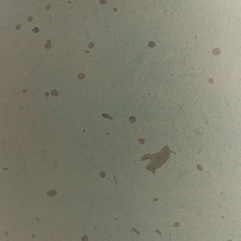 Green ceramic vase texture with scattered speckles and mottled spots