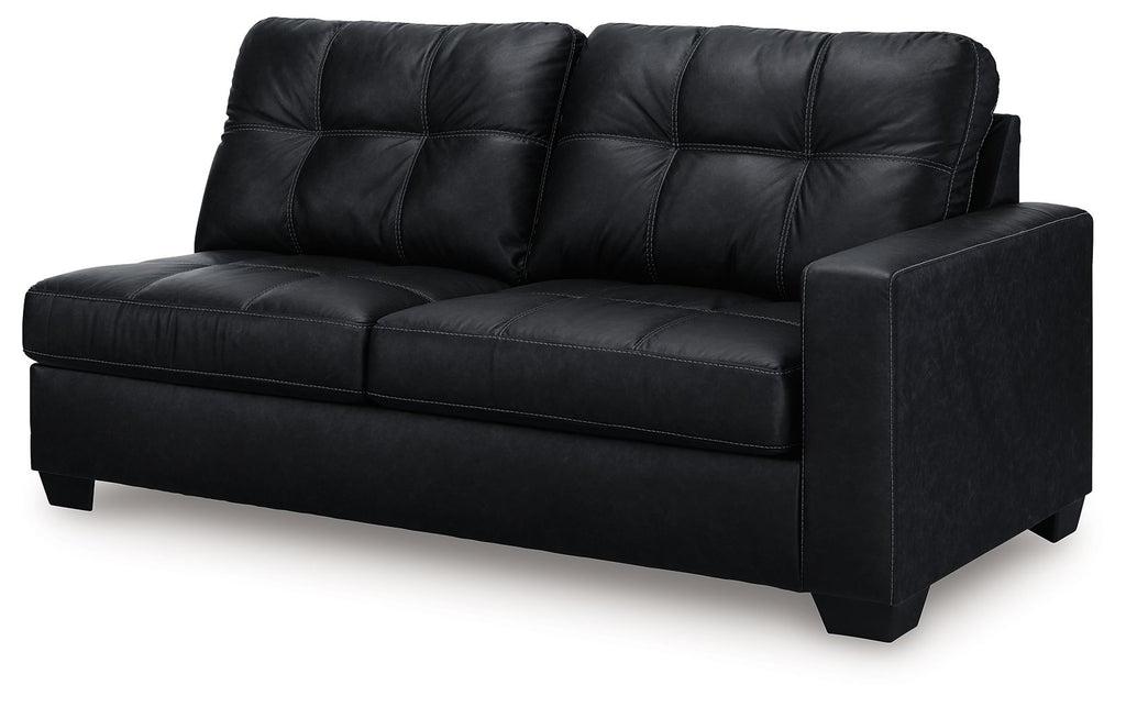 Dark two-seat sofa with tufted back panels, wide seat cushions, and block legs