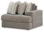 Ash gray corner chair with wide arms and four accent throw pillows