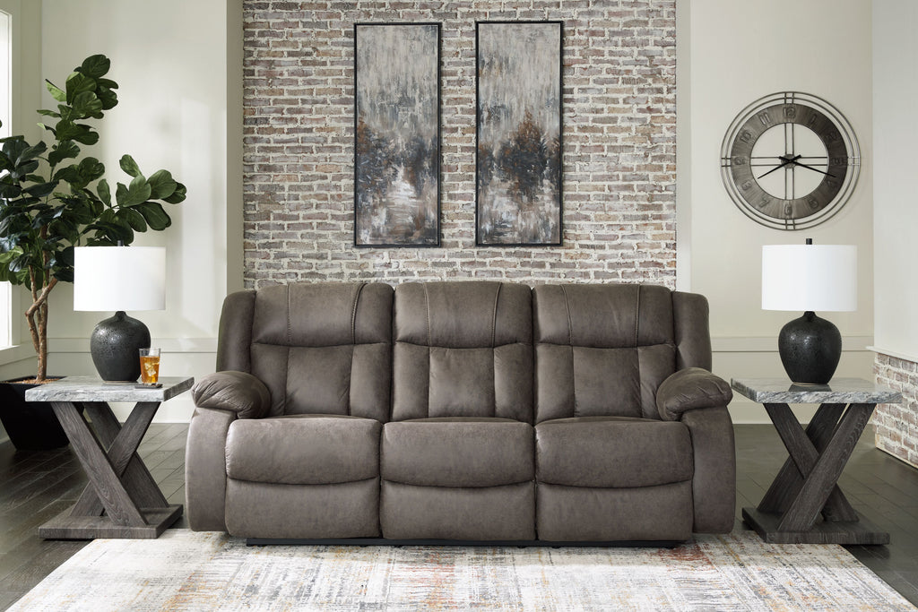 Gunmetal reclining sofa in living room with three-seat back and padded arms