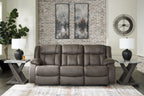 Gunmetal reclining sofa in living room with three-seat back and padded arms