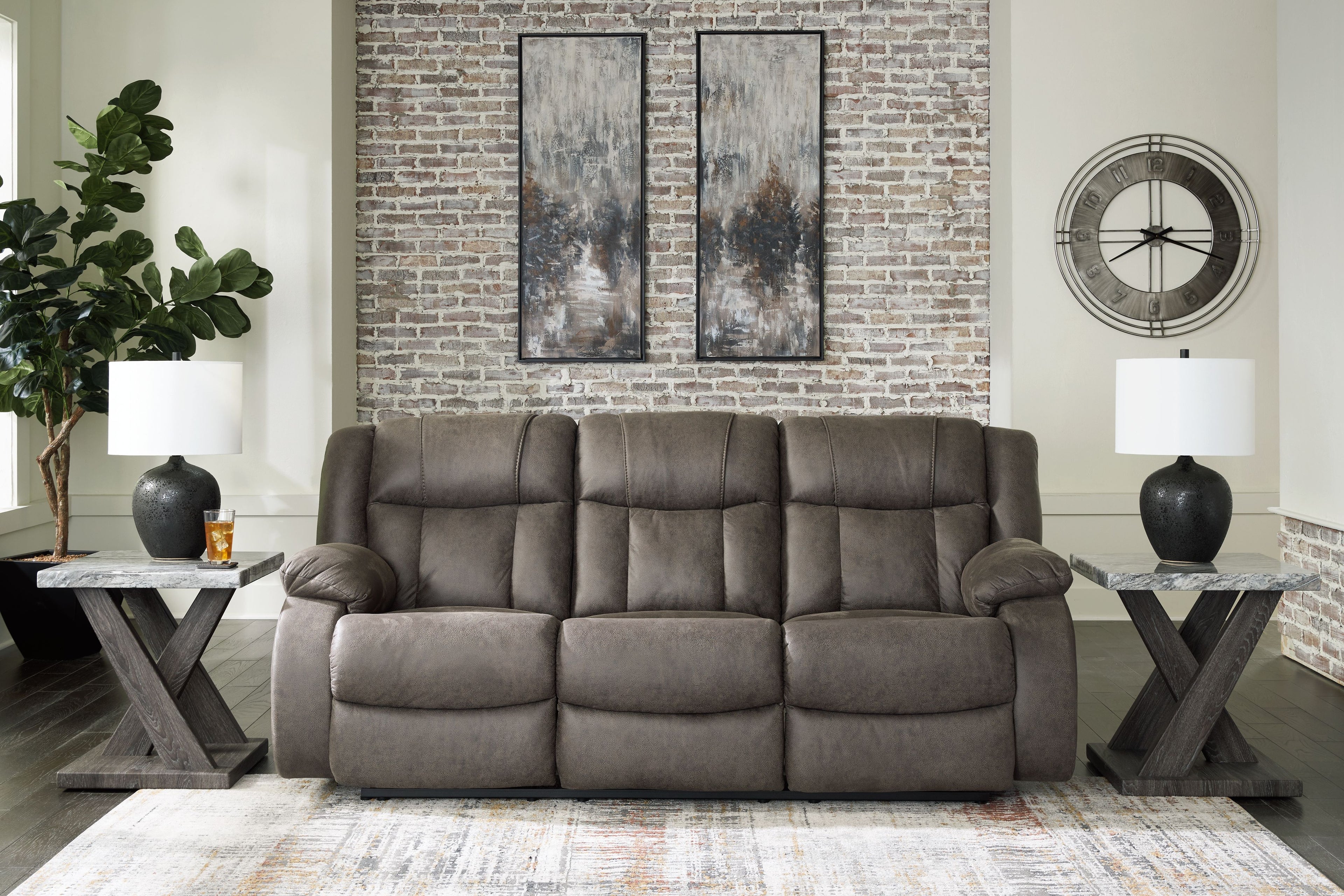 Gunmetal reclining sofa in living room with three-seat back and padded arms