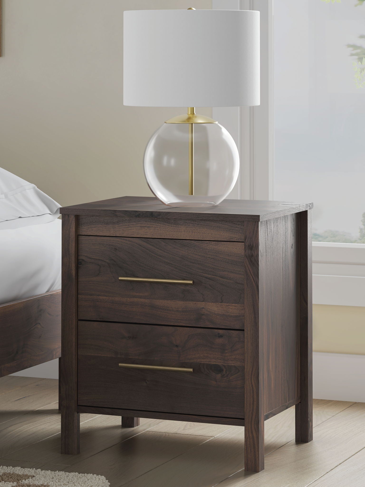 Calverson Night Stand with two drawers and brass bar pulls next to a lamp