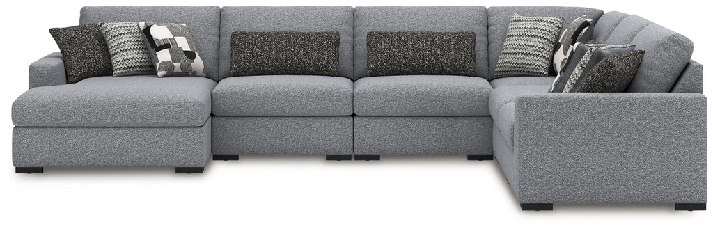 Sectional sofa with right chaise in dark-and-light gray, with patterned throw pillows
