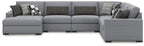 Sectional sofa with right chaise in dark-and-light gray, with patterned throw pillows