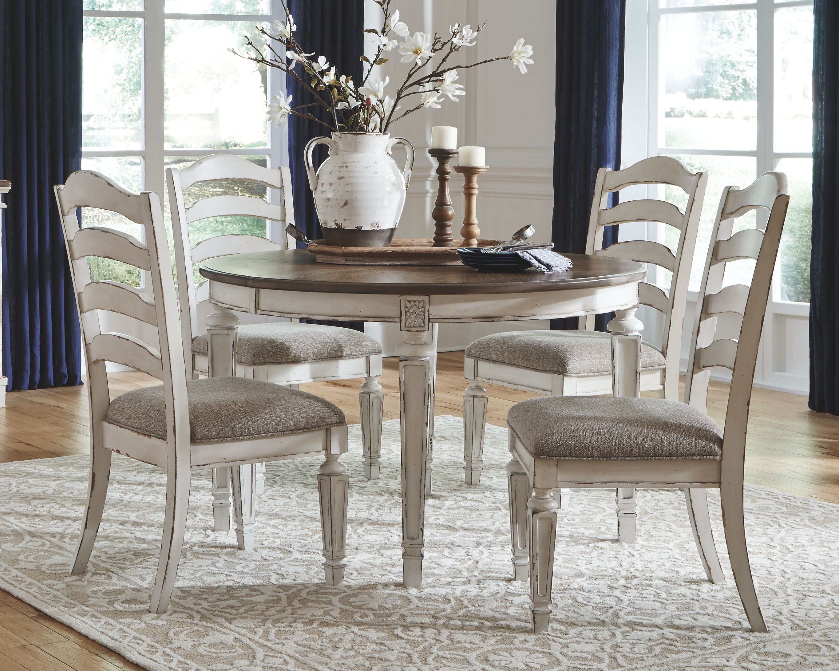 Oval dining table set with white chairs, upholstered seats, gray-brown tabletop