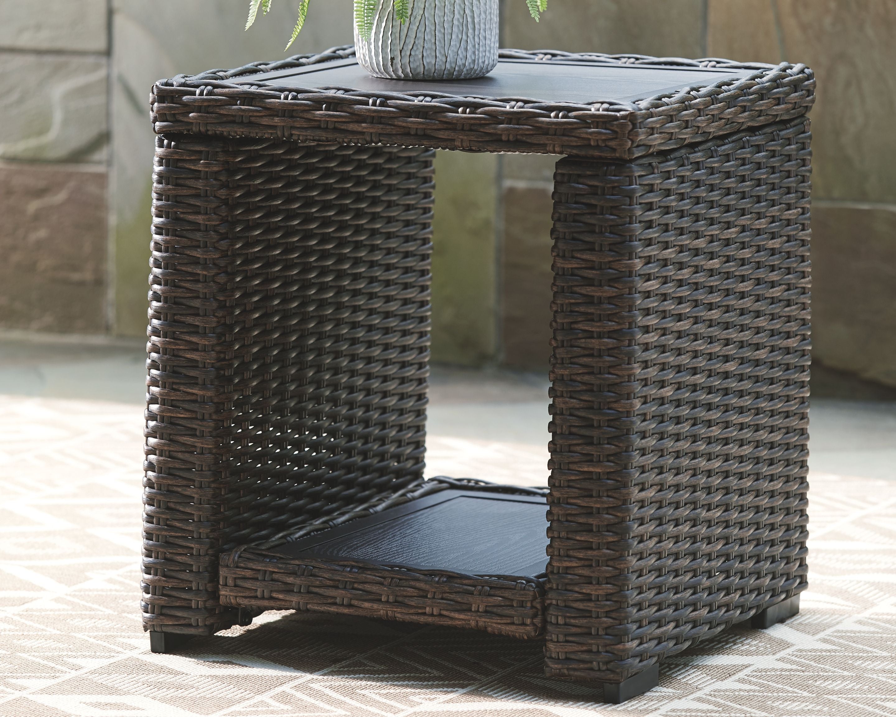 Dark woven square end table with lower shelf and open-frame sides