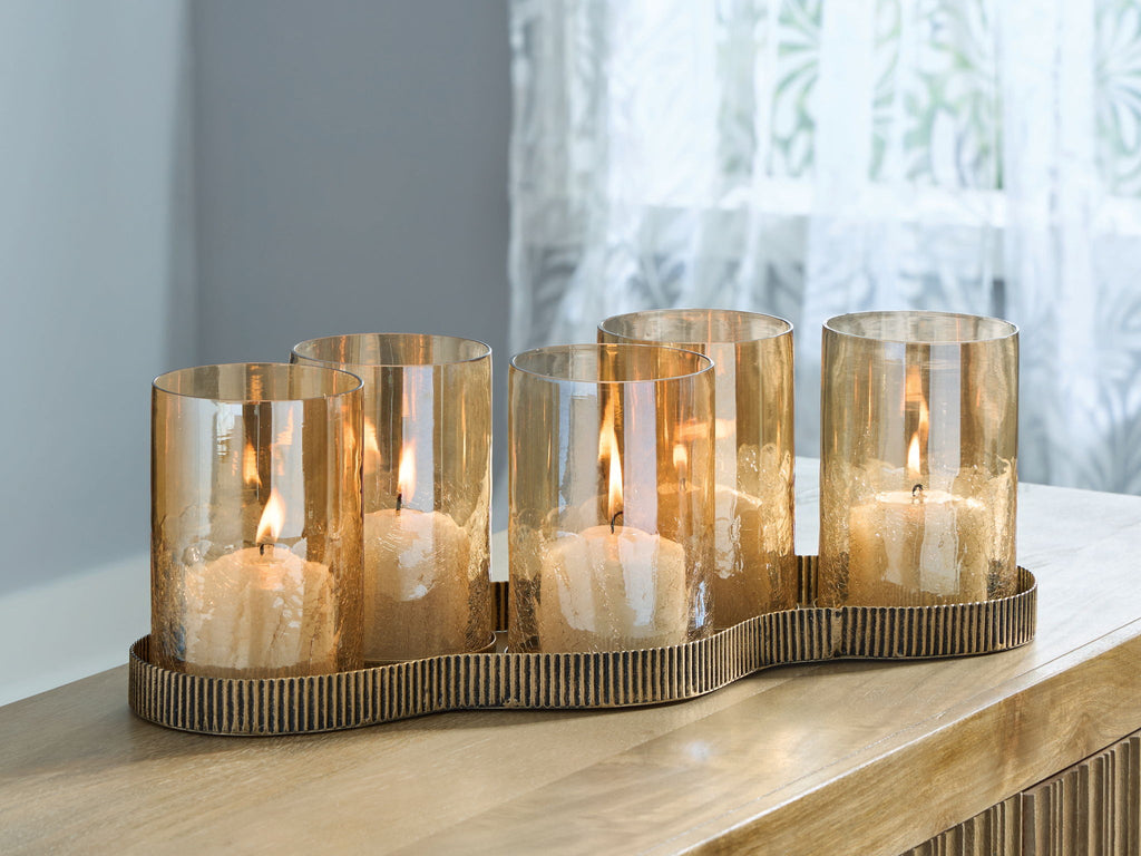 Antique gold candle holder with five lit cylindrical glass cups on ridged tray