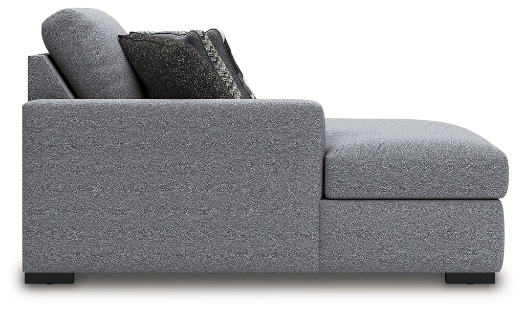 Grey upholstered chaise with curved side arm and block feet, side view