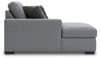 Grey upholstered chaise with curved side arm and block feet, side view