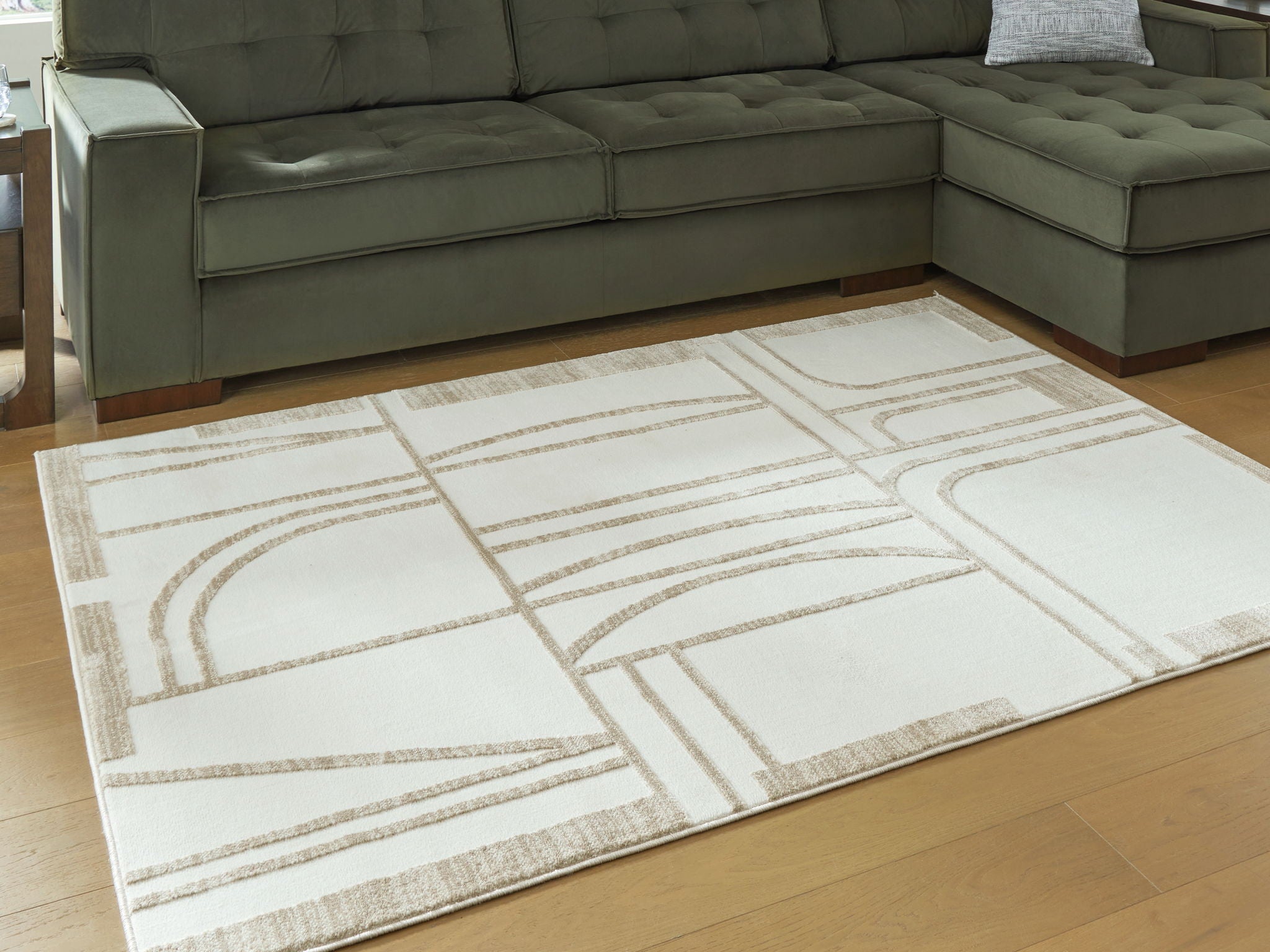 Beige area rug with abstract geometric pattern in off-white and tan, flat weave
