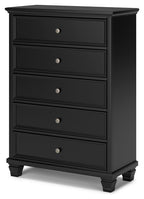 Black five-drawer chest with round knobs and carved drawer trim
