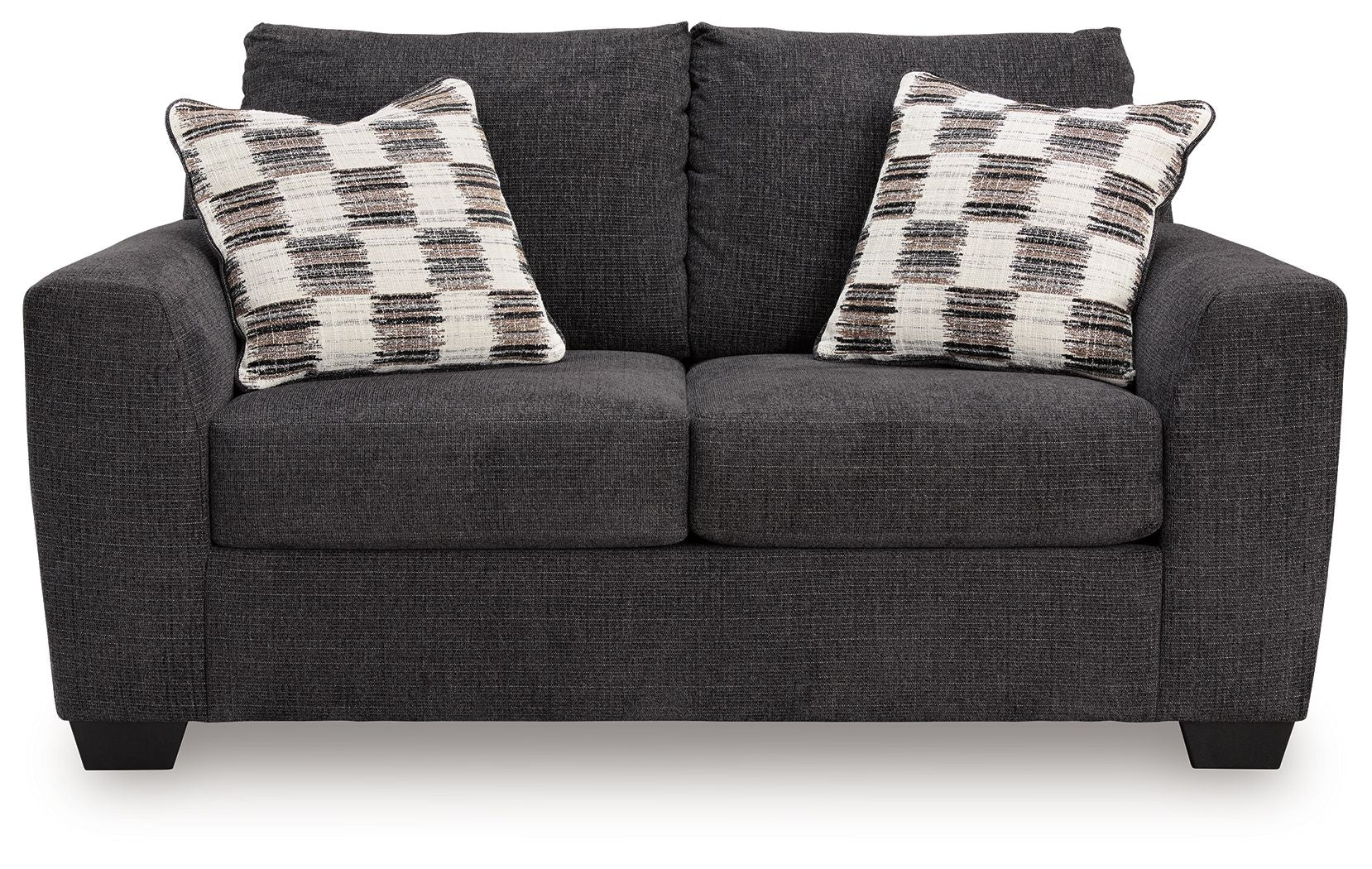 Dark gray loveseat with two plaid throw pillows and tufted seat back