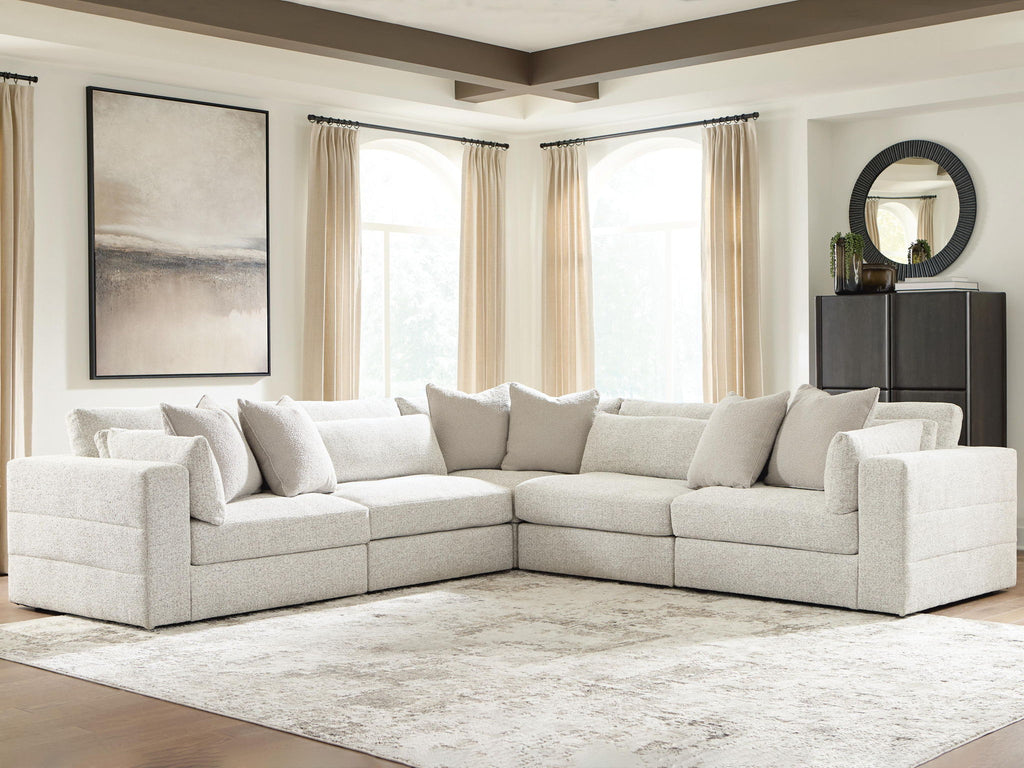 Beige sectional sofa with chaise and corner section, throw pillows and thick padded armrests