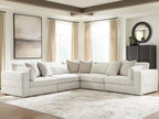 Beige sectional sofa with chaise and corner section, throw pillows and thick padded armrests