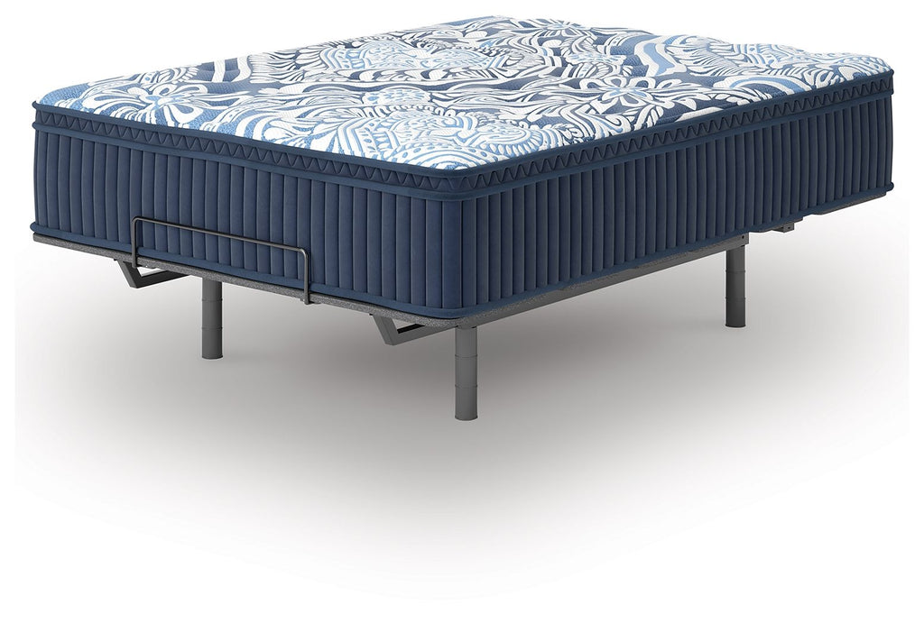 Blue mattress with patterned top, ribbed sides, and metal side handle