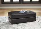 Onyx leather ottoman with padded top and square base on short legs