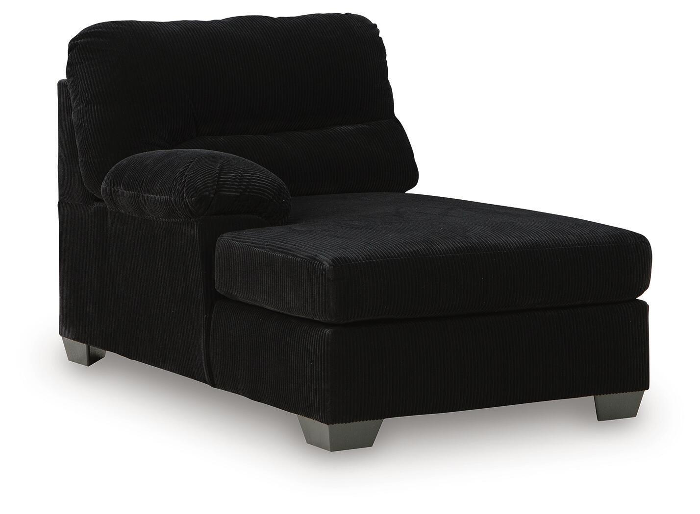 Corner chaise with dark corduroy upholstery, cushioned back, and ottoman-style seat