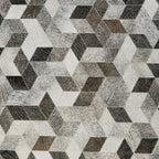 Geometric pouf fabric pattern with gray, black, and off-white cube shapes