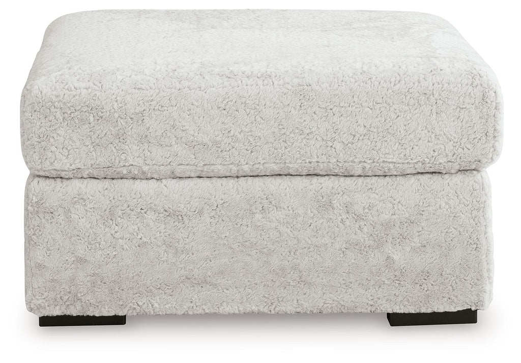 Light gray oversized accent ottoman with textured upholstery and padded lid