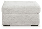 Light gray oversized accent ottoman with textured upholstery and padded lid