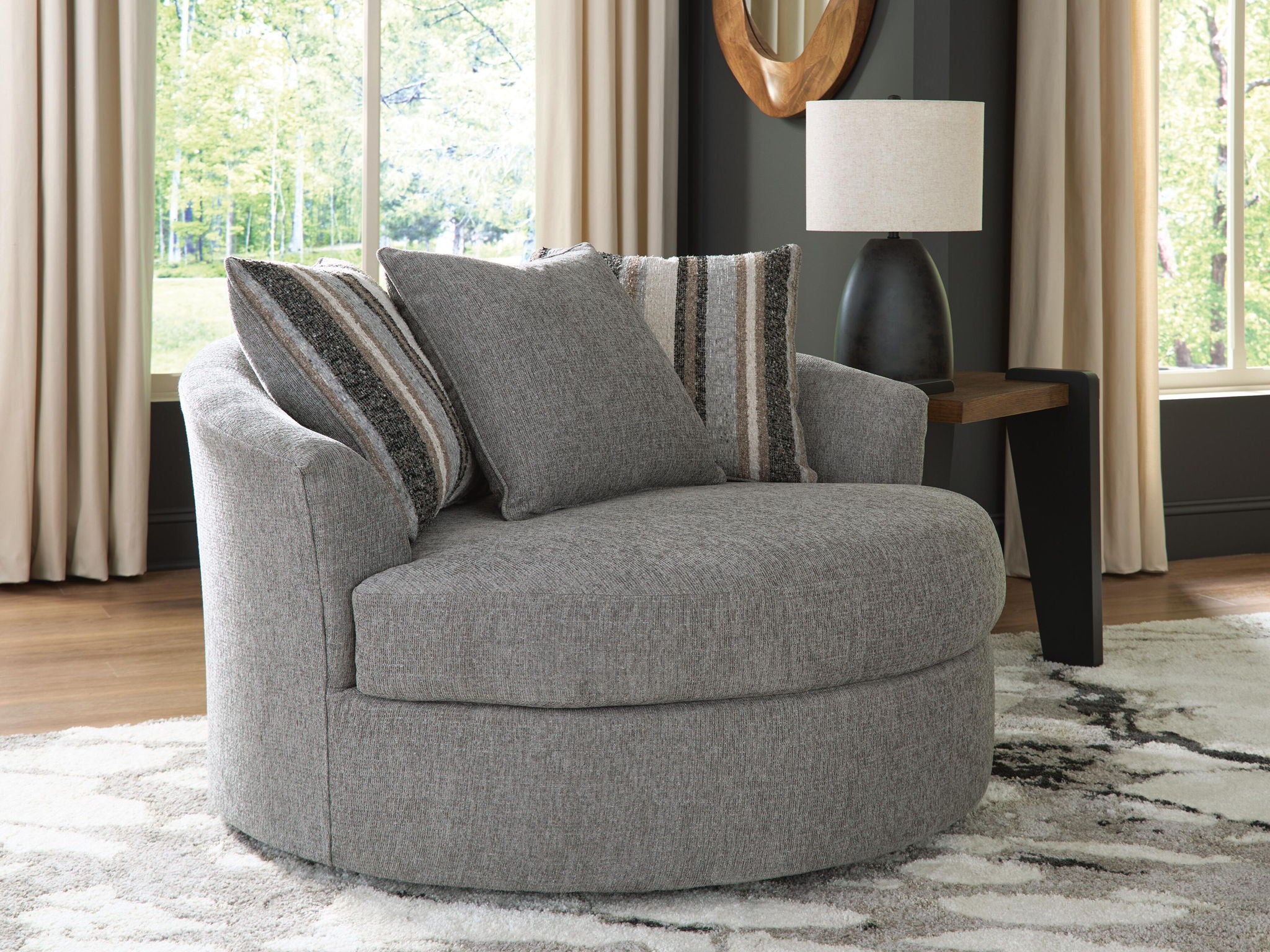 Gray swivel accent chair with wide seat and striped back cushions