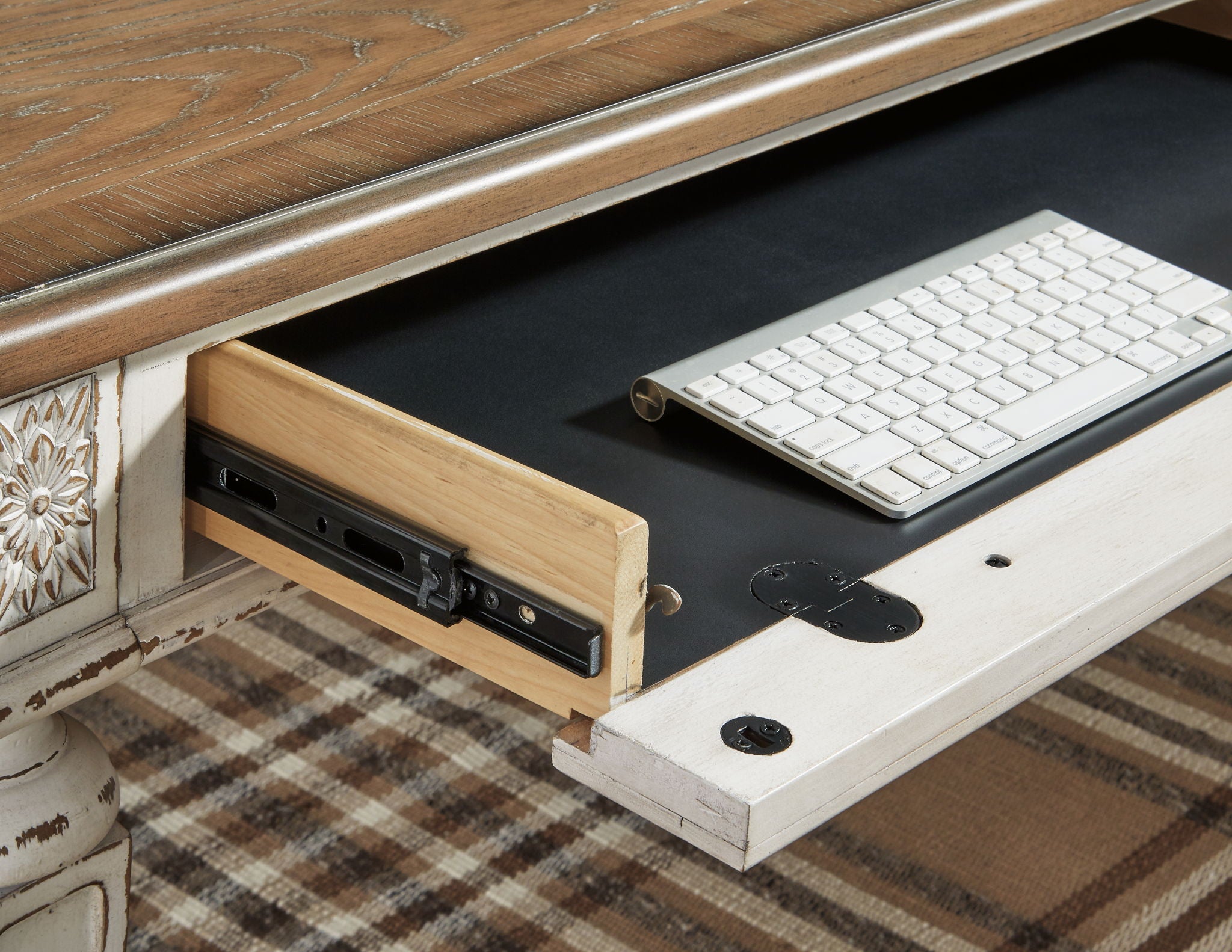 L-shaped desk showing keyboard area, drawer with hardware, and white base