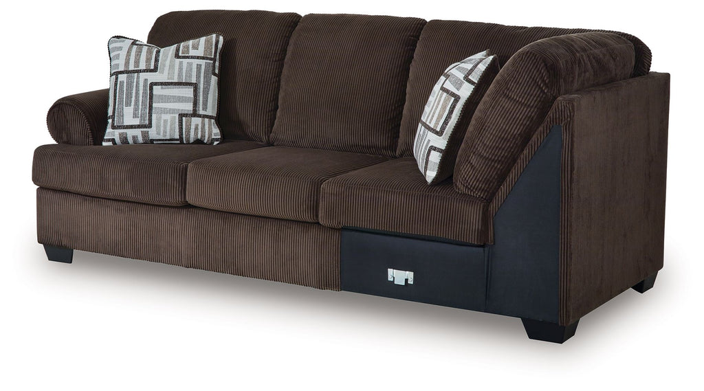 Dark brown corner wedge sectional sofa with armrests, seat cushions, and patterned pillows